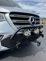 Front view of an RV rental Mercedes-Benz Sprinter with a heavy-duty bumper, LED lights, and front hitch.
