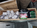 RV rental drawer stocked with K-cups, tea bags, and sweeteners for your coffee or tea needs during your trip.
