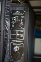 This RV rental's water control panel shows settings for fresh water, siphon, external port, and an outdoor shower.