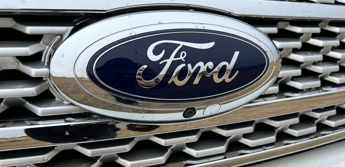Ford vehicle's front grille, emblem, and camera, ideal for your next RV rental journey.