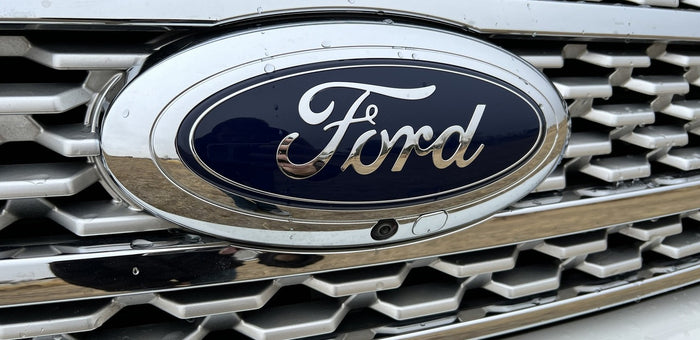 Ford vehicle's front grille, emblem, and camera, ideal for your next RV rental journey.