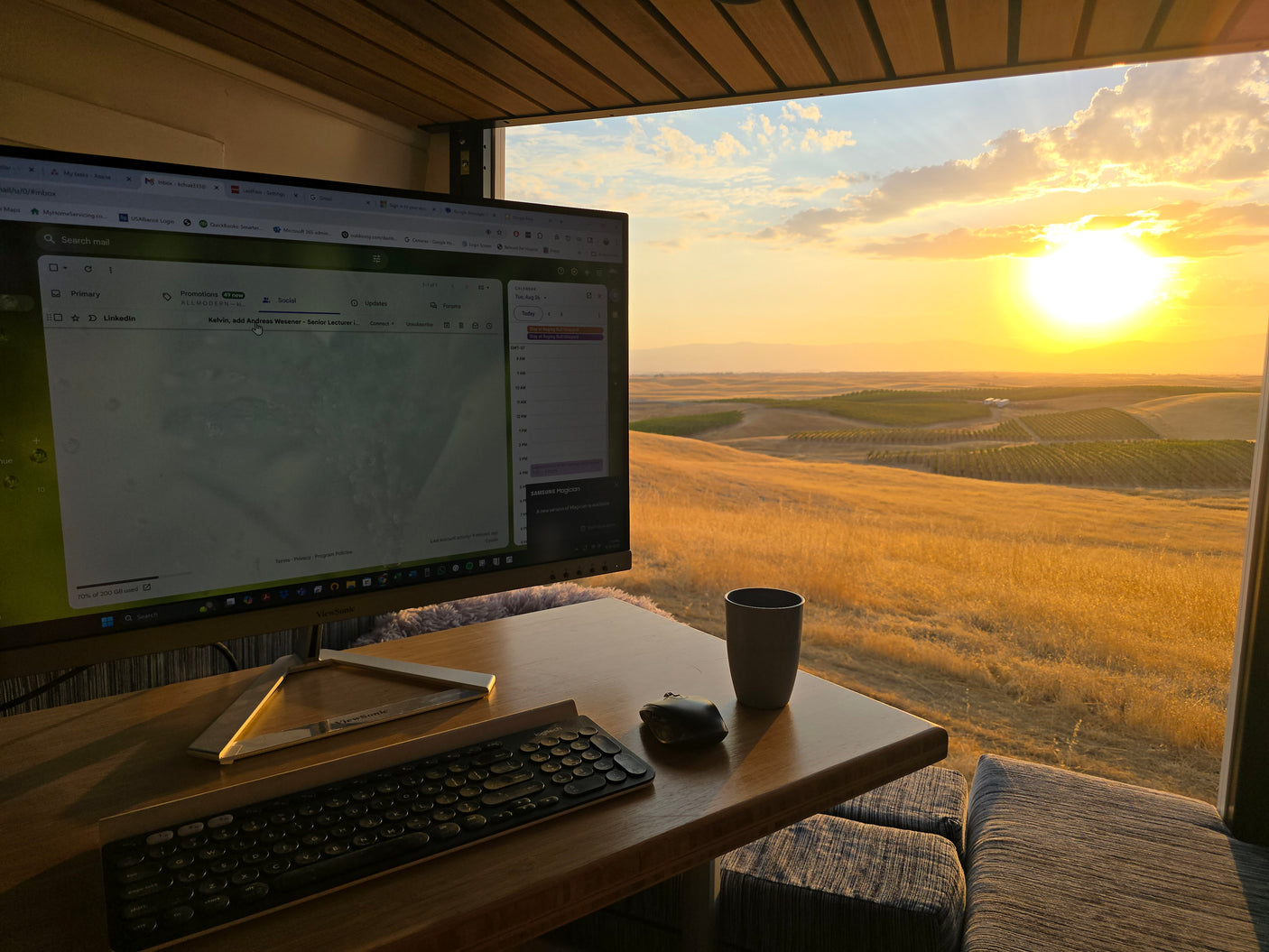RV rental office with a stunning golden sunset view over rolling hills and vineyards, perfect for remote work.