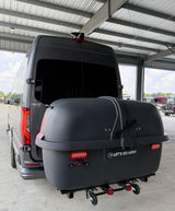 This grey RV rental van features a large "Let's Go Aero" rear cargo box, ideal for travel storage.