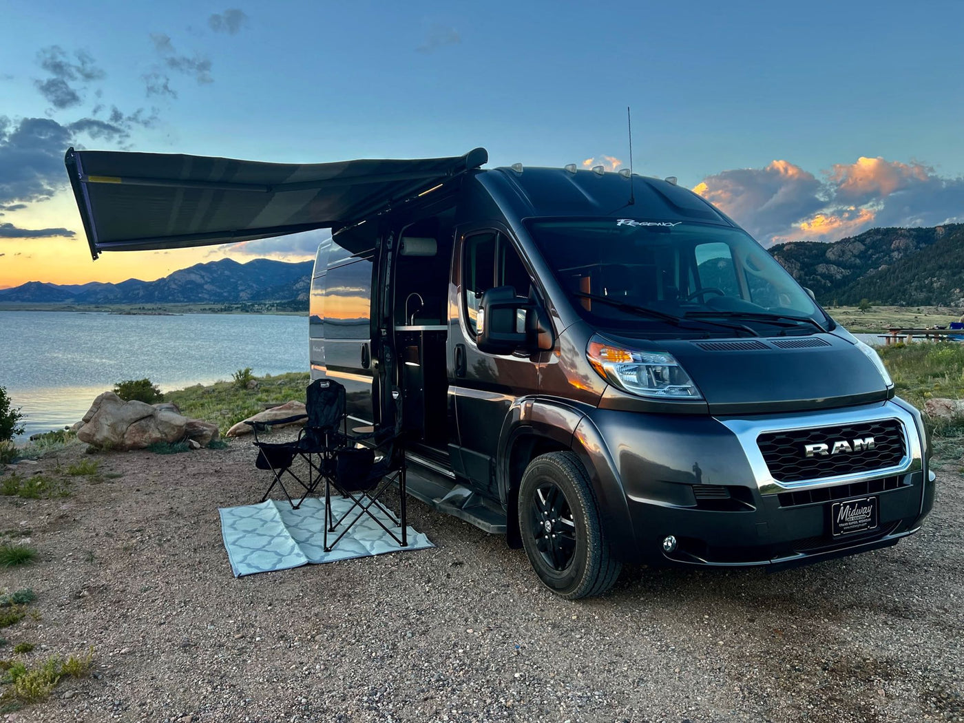  cloudy sky.|RV rental van offers stunning lakefront sunset views at a scenic campsite for your nature travel adventure.|Stylish dark gray rv rental camper van parked by a scenic lake at sunset with mountains and camping chairs set up.|Cozy RV rental interior with a stunning lake and mountain view at dusk. Ideal for peaceful getaways.|Inside a cozy rv rental with a modern kitchenette — photo 10
