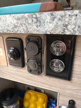 RV rental interior featuring essential charging ports (USB, 12V marine) and child-proofed AC power outlets for safety.