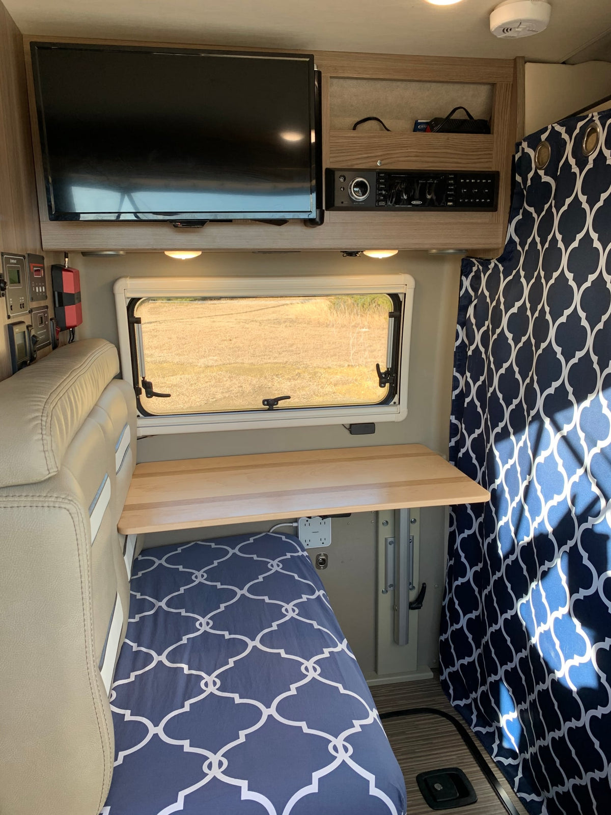  parked on gravel with mountains & forest in the background. Side door open for fresh air.|RV rental parked lakeside — photo 15