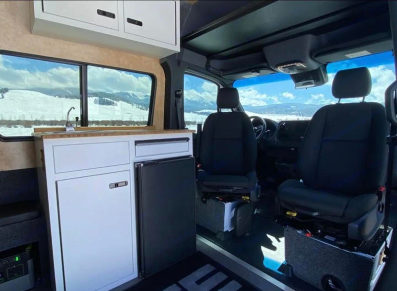  highlighting a great travel experience.|Inside a modern RV rental: a compact kitchen — photo 8