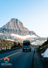Grey Moterra campervan on a winding mountain road with snow. Your next RV rental adventure awaits here.