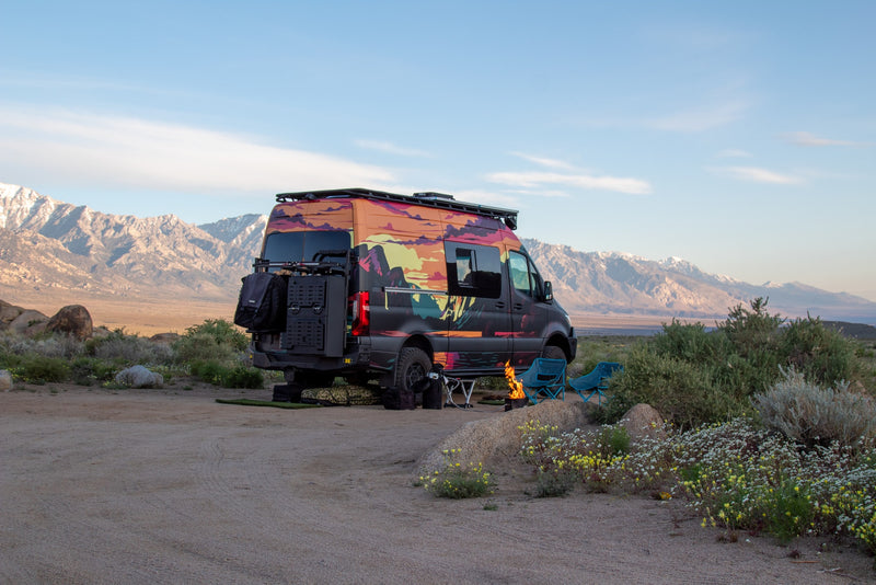  backed by snowy mountains.|This colorful RV rental is perfectly set up for a desert camping adventure with a fire pit and mountain views.|This vibrant RV rental is parked at a desert campsite — photo 6