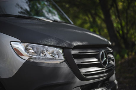 Close-up of a Mercedes-Benz Sprinter van with textured hood, ideal for your next rv rental adventure.