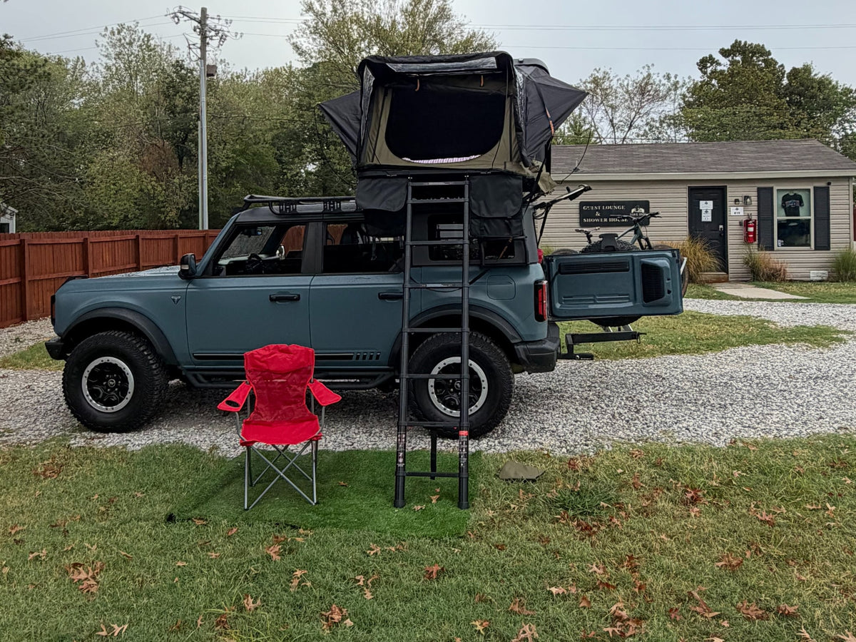  ready for camping adventures at site #12 with its bike.|Adventure-ready SUV with NaturNest rooftop tent & Allied mountain bike — photo 3