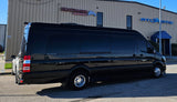 Black luxury Sprinter van, ideal for rv rental, with tinted windows & chrome wheels. Parked by Atlantic Aviation.