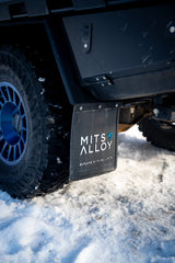 Off-road adventure ready: this RV rental features rugged tires and custom Mits Alloy mud flaps for snowy exploration.