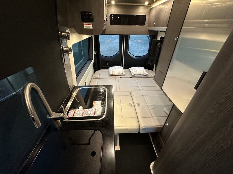  and a clear view of the road ahead.|This RV rental interior reveals a compact kitchen (sink — photo 2
