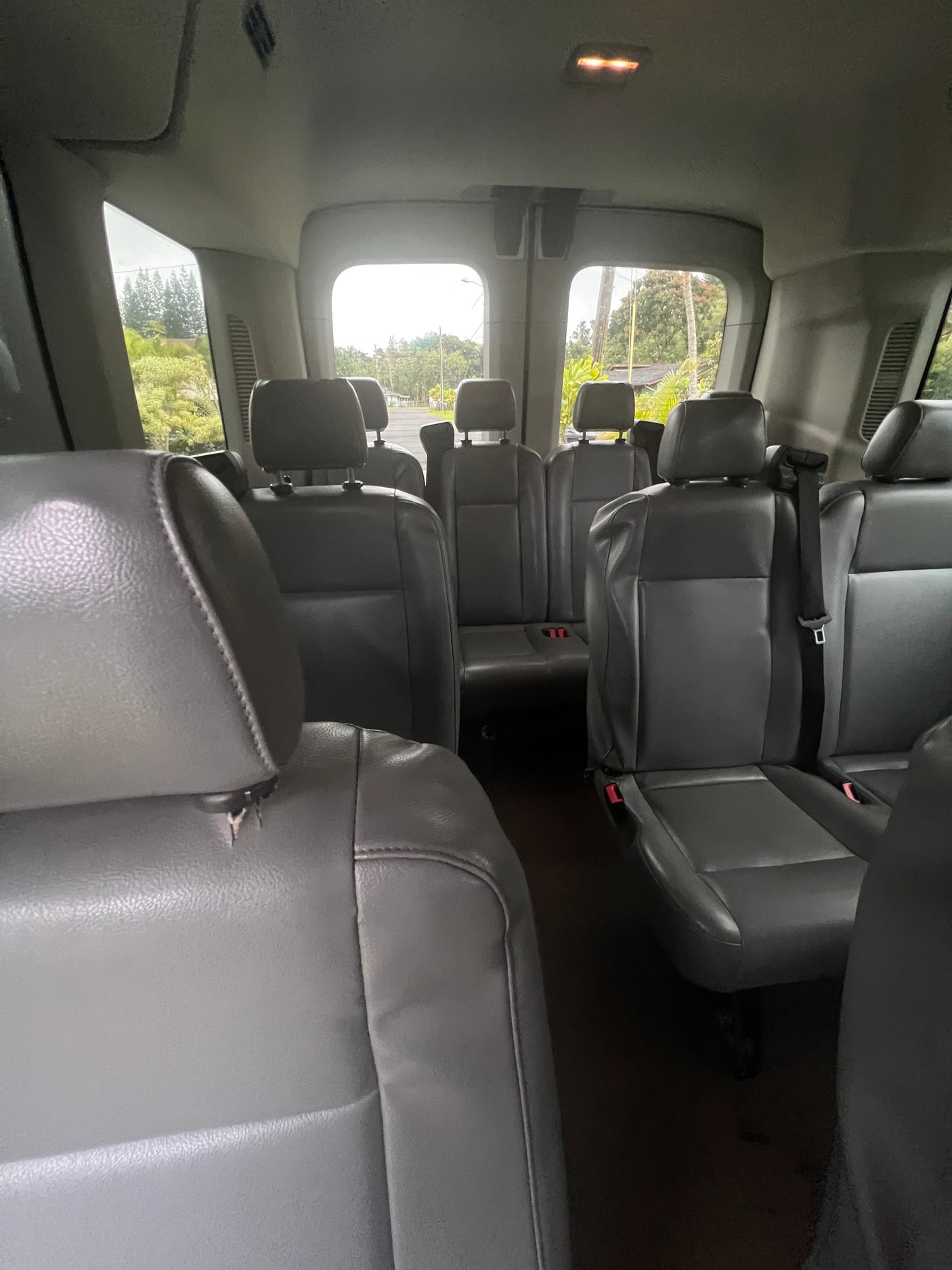 Spacious RV rental interior with multiple rows of comfortable grey passenger seats, perfect for group transport.