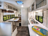 Step inside this RV rental! Enjoy a bright interior with a dining booth, functional kitchenette, and beautiful window views.