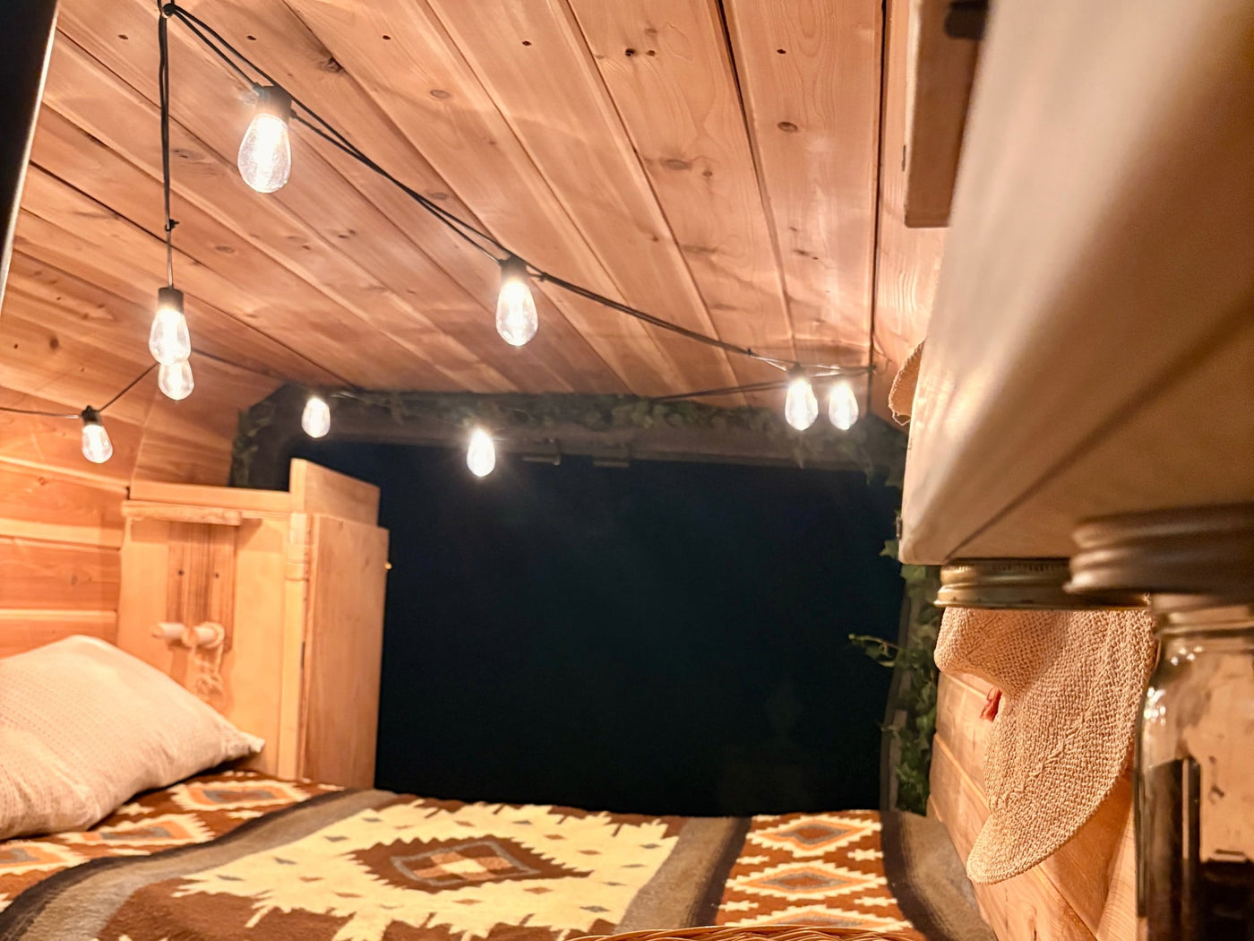  parked outdoors near trees.|||||||Cozy RV rental interior with a fluffy steering wheel cover & seat — photo 9