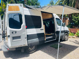 White Sprinter camper van with awning extended, perfect for your next rv rental adventure.