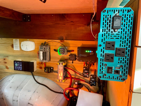 RV electrical system: inverter, charge controller, fuses, and battery monitor display. Essential for an RV rental journey, with a smoke alarm.