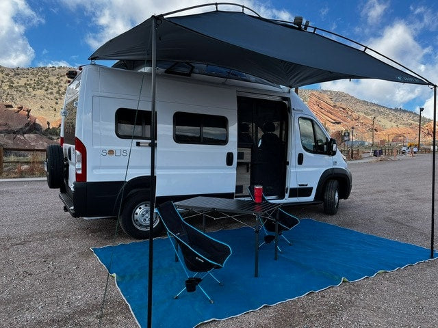  amidst red rock formations.|Rear view of an RV rental van with open doors — photo 20