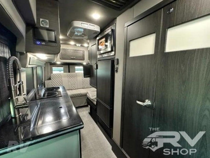  quilted bench seating and large windows for travel.|Modern RV rental interior: Light-colored — photo 12