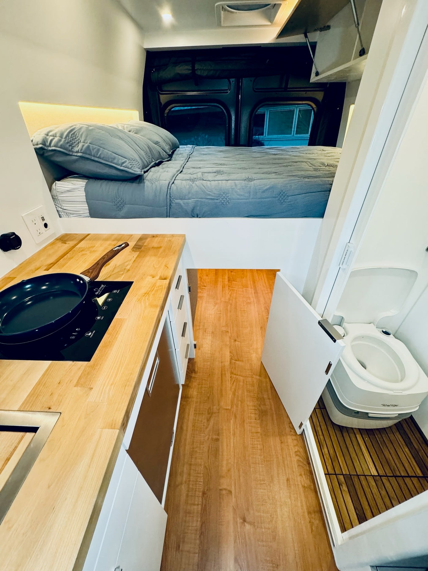  chair & blanket.|Dark gray camper van with awning extended — photo 6