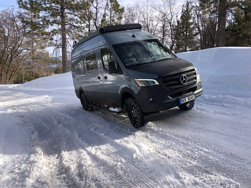 Rugged gray Mercedes Sprinter RV rental camper van on a snowy winter road, ideal for adventure travel. — photo 15
