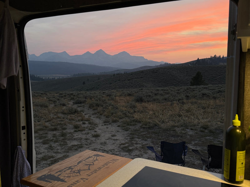  and majestic peaks.|Adventure awaits! A smiling couple poses with their RV rental camper van at an outdoor campsite — photo 7