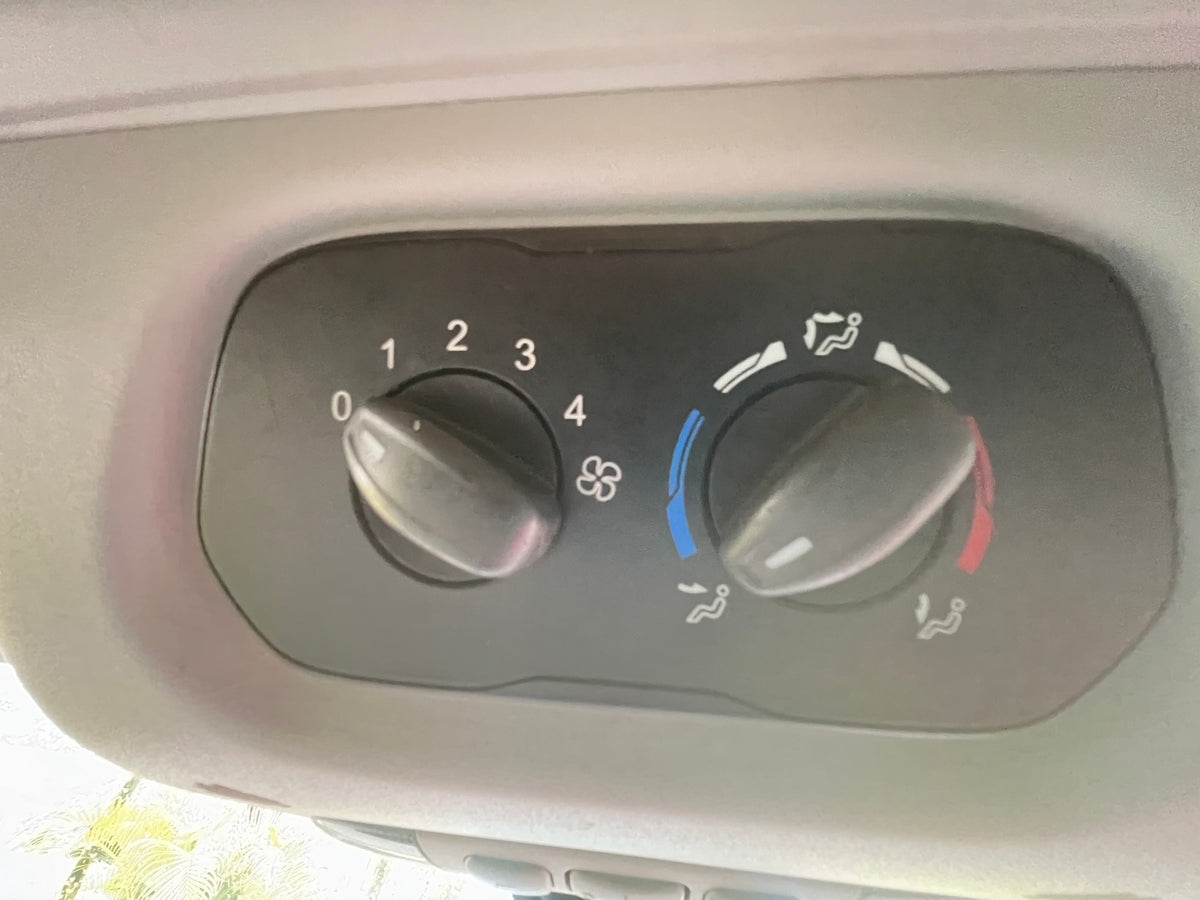  showing multiple rows of grey seats and seatbelts with outside views.|Spacious grey passenger van interior — photo 10