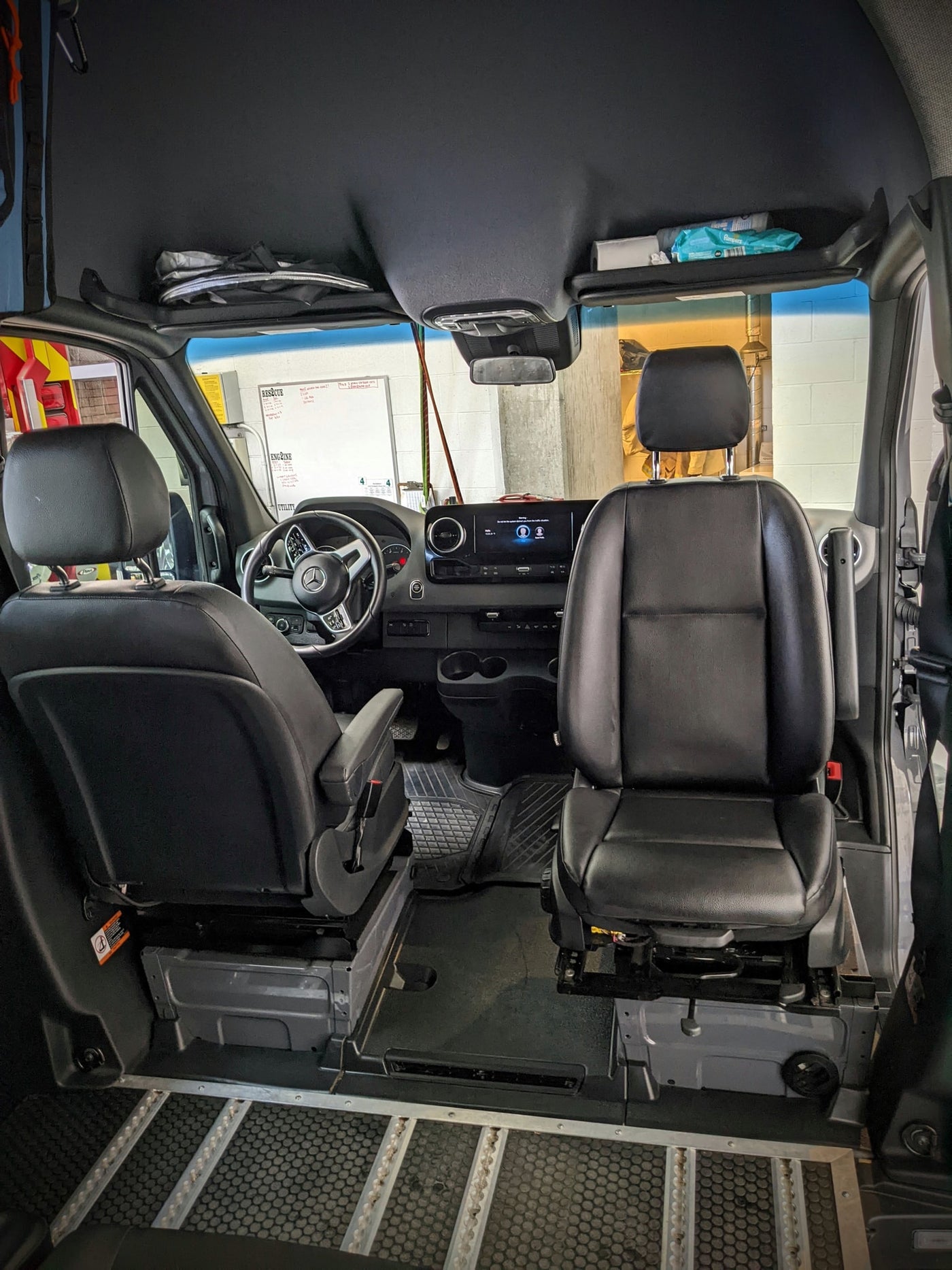  suggesting travel.|Rear view of a spacious RV rental van with open doors revealing bunk beds — photo 16
