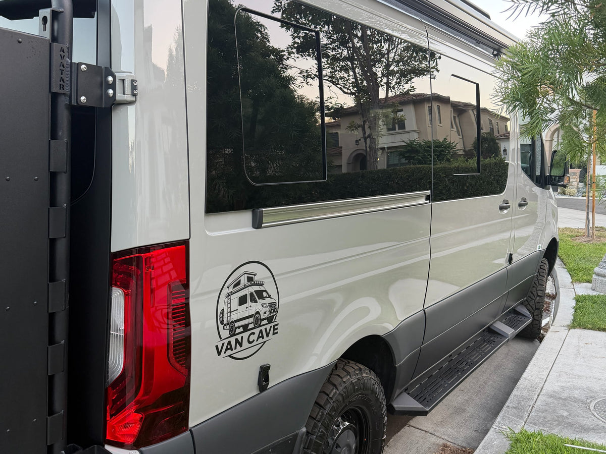  parked in a scenic desert landscape with majestic mountains under a clear sky.|An adventure-ready Sprinter camper van rv rental parked in a rocky desert landscape under a clear blue sky — photo 5