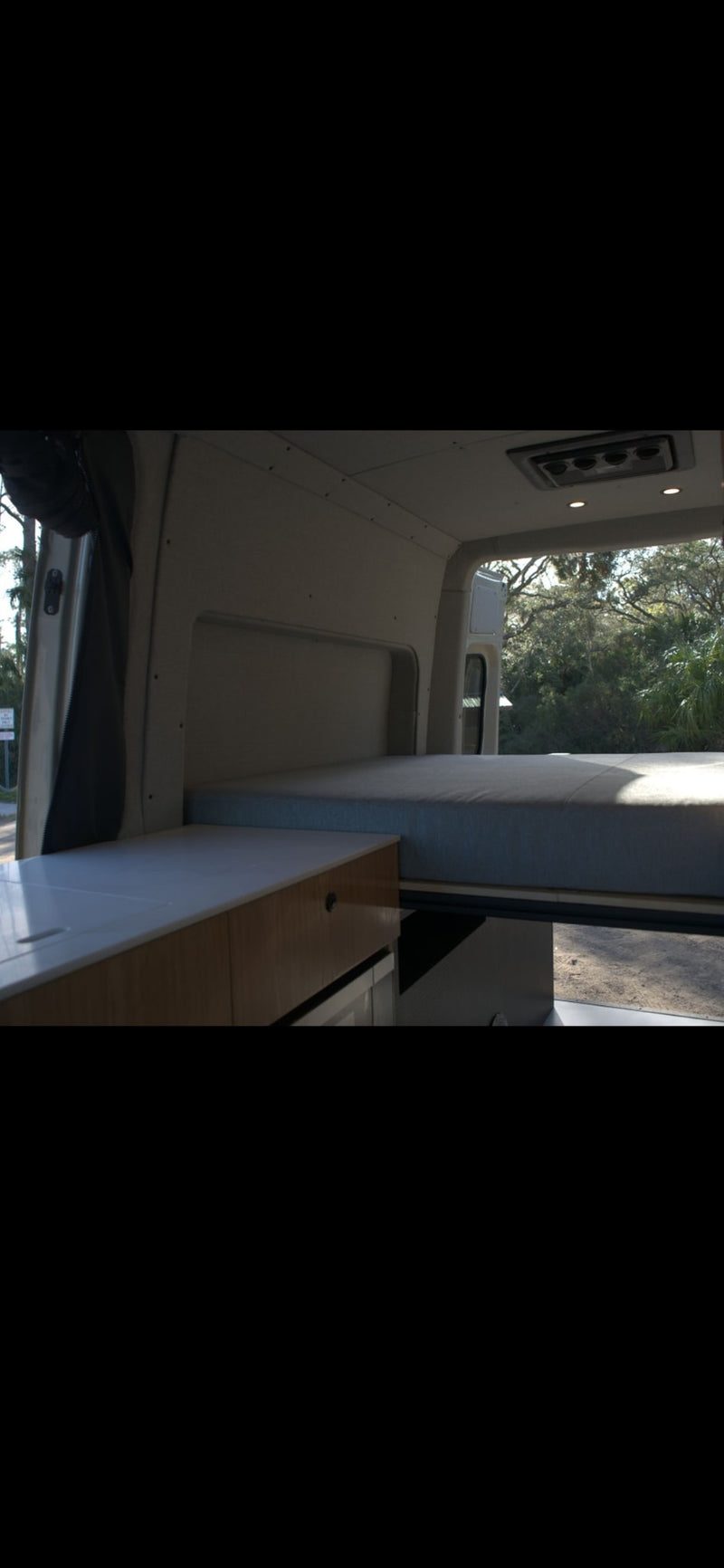  and a view of nature.|RV rental camper van interior revealed with open door — photo 6