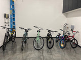 RV rental ready: Organized garage with 7 bikes, ladders, and wall storage for adventure seekers.