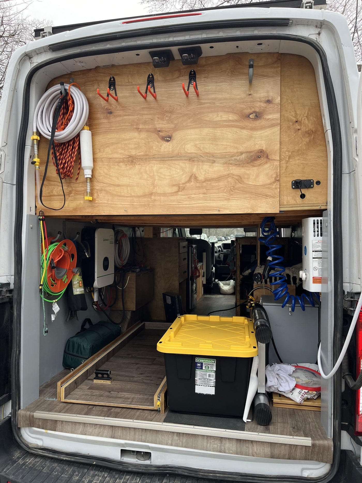  and vibrant geometric wall decor.|RV rental: Inside a modern camper van with a full kitchen — photo 11