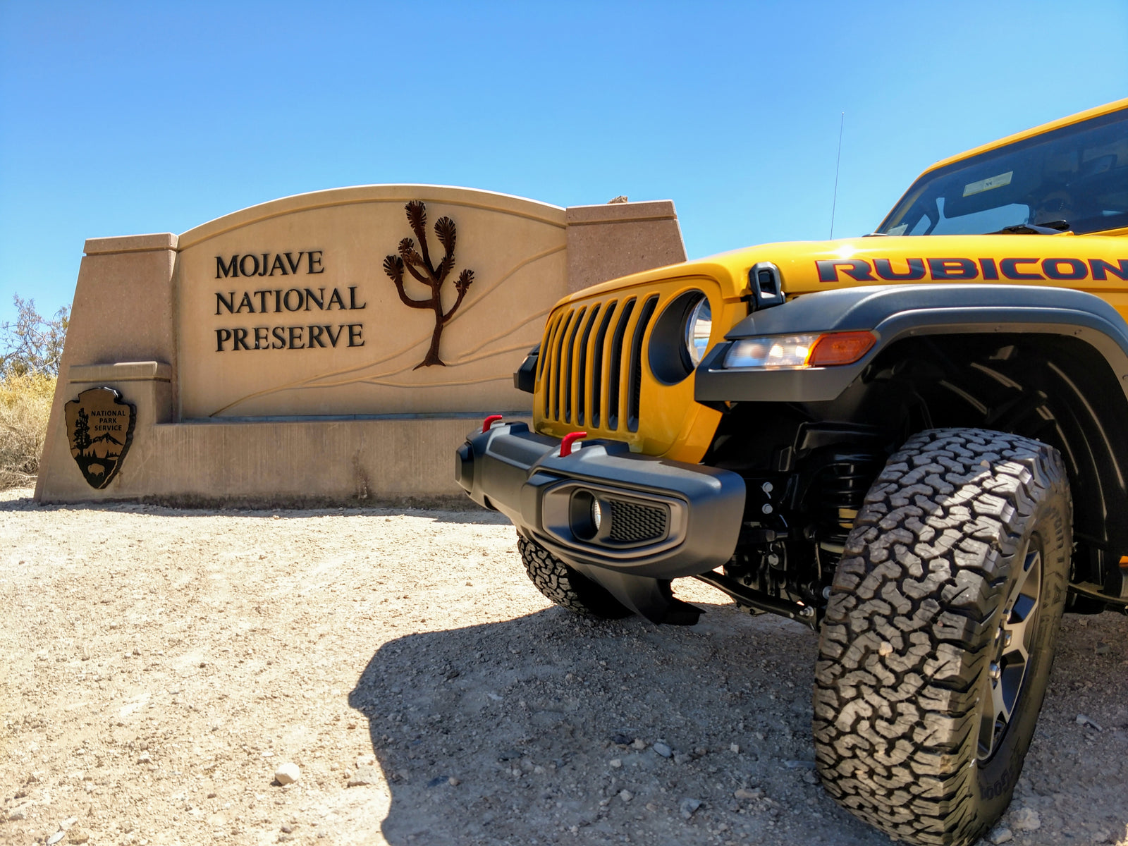 Yellow Jeep Rubicon at Mojave National Preserve entrance, perfect for an off-road RV rental adventure.