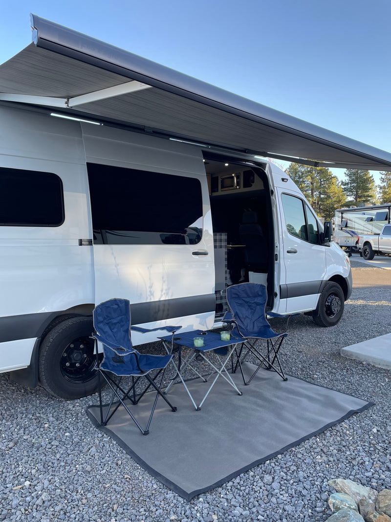  seating & front cabin for travelers.|This **RV rental** camper van interior features a dirt bike — photo 13