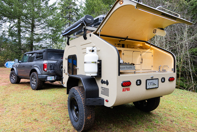 Rugged off-road teardrop trailer (rv rental) & Ford Bronco, perfect for overland adventures with an outdoor kitchen.