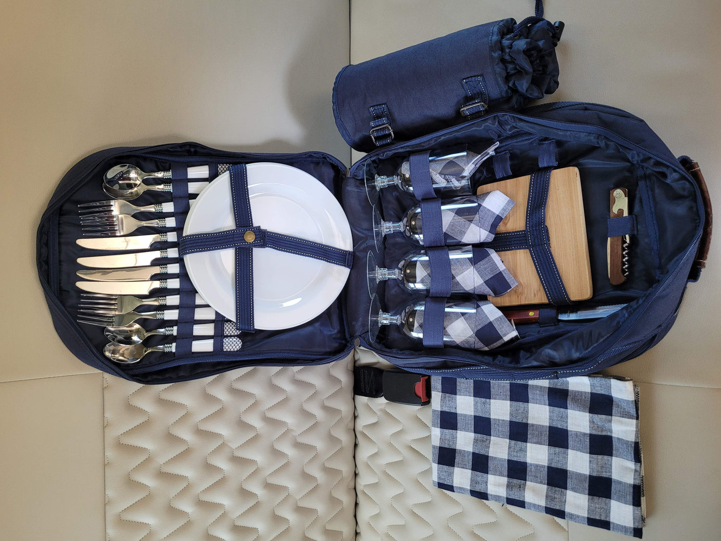 RV rental ready: Complete picnic set with cutlery, glasses, plates, board, and blankets, neatly packed for travel.