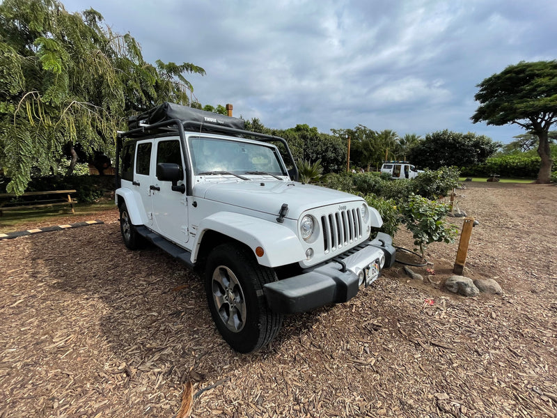 A white Jeep Wrangler with a Thule Tepui rooftop tent, perfect for an adventurous RV rental getaway. — photo 19