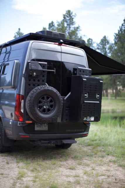  perfect for adventure.|Spacious grey camper van with extended awning and open side — photo 7