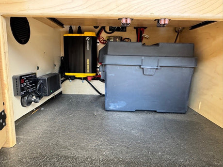 Interior storage compartment with battery bank and power electronics