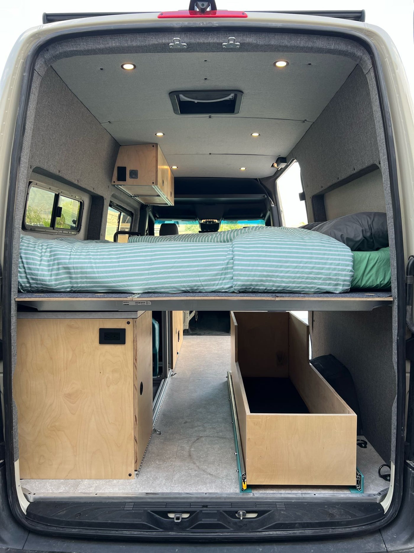  and roof rack.|Rugged Mercedes-Benz Sprinter adventure van parked on a driveway with side door open — photo 14