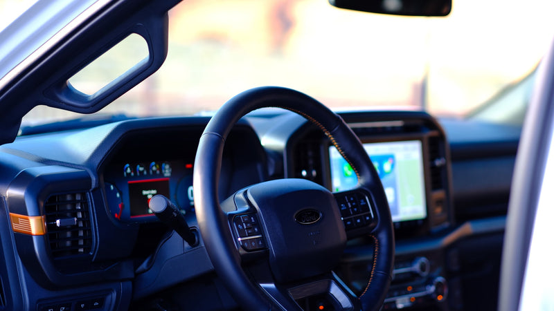 Spacious, modern RV rental interior: view of the dashboard, steering wheel with controls, and large navigation screen. — photo 12