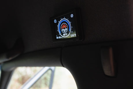 RV rental: Digital climate control panel in a camper interior, showing 55°F, 155°F heating, time, and fan speed settings.