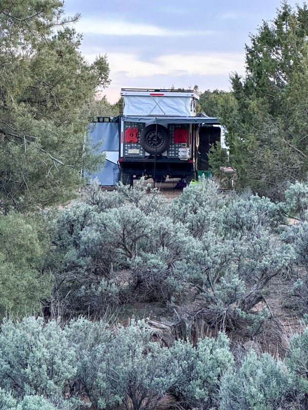 Discover remote camping: an overland RV rental camper with a rooftop tent nestled among sagebrush, ideal for off-grid adventure. — photo 10