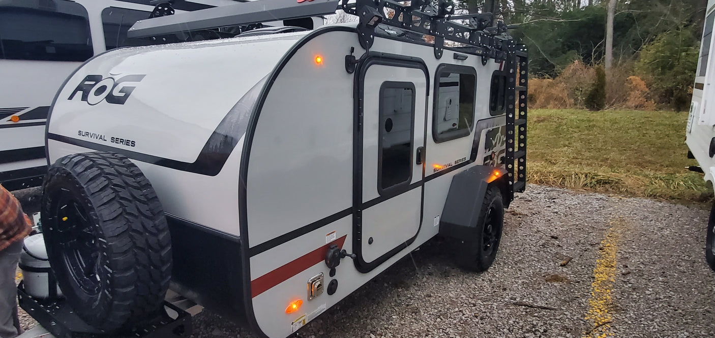 Adventure RV rental: A rugged ROG Survival Series travel trailer with off-road tires, ready for camping.