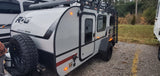Adventure RV rental: A rugged ROG Survival Series travel trailer with off-road tires, ready for camping.