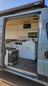Step into this modern RV rental! Features include a custom kitchen, microwave, slide-out fridge, and solar panels.