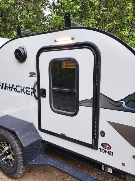 Explore the rugged Bushwhacker 10HD travel trailer, ideal for your next RV rental and camping adventure.
