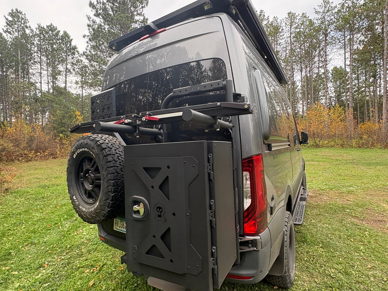  parked in a forest with autumn trees.|Rugged RV rental camper van parked in a scenic forest clearing — photo 13